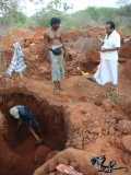 Miners work as a Mudelali watches